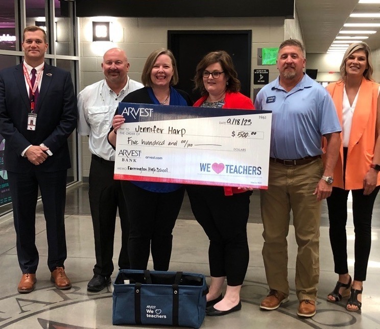 Teacher and Arvest employees posing with big heck