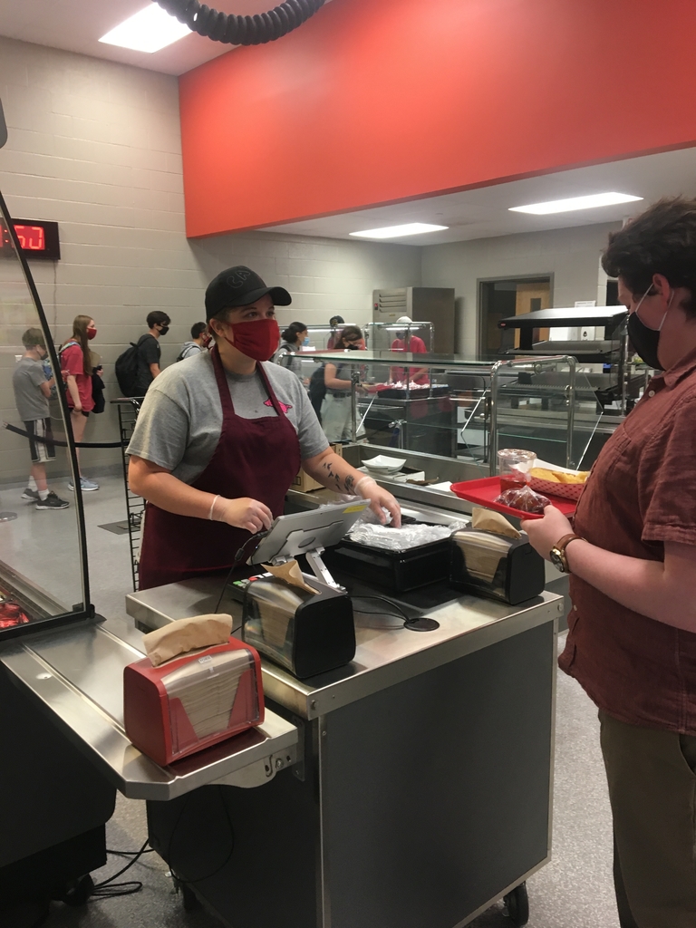 Lunch server cashing a student out