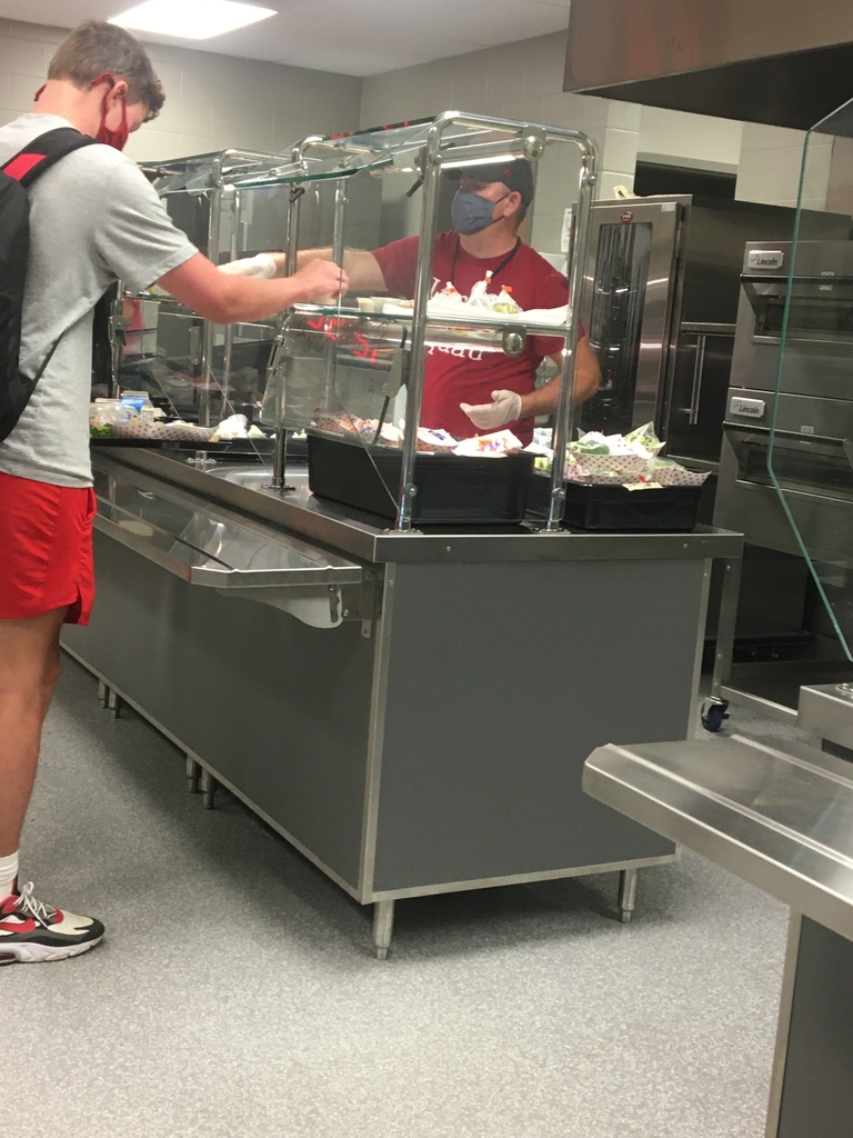 Lunch server serving student food