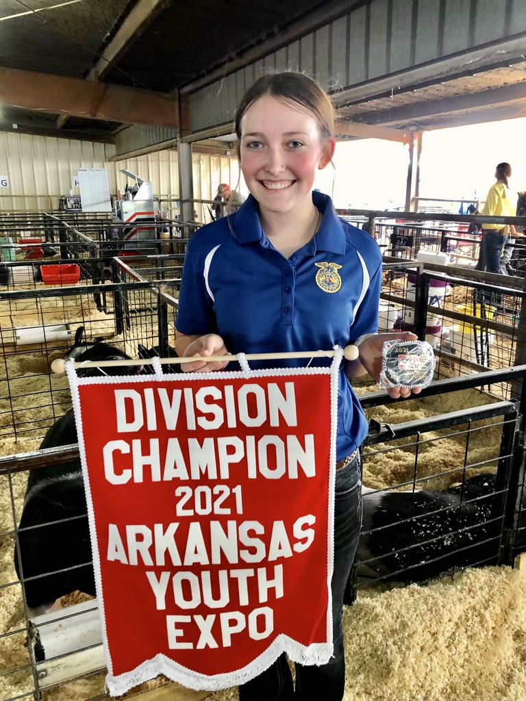 Chambers holding her champion flag & belt buckle