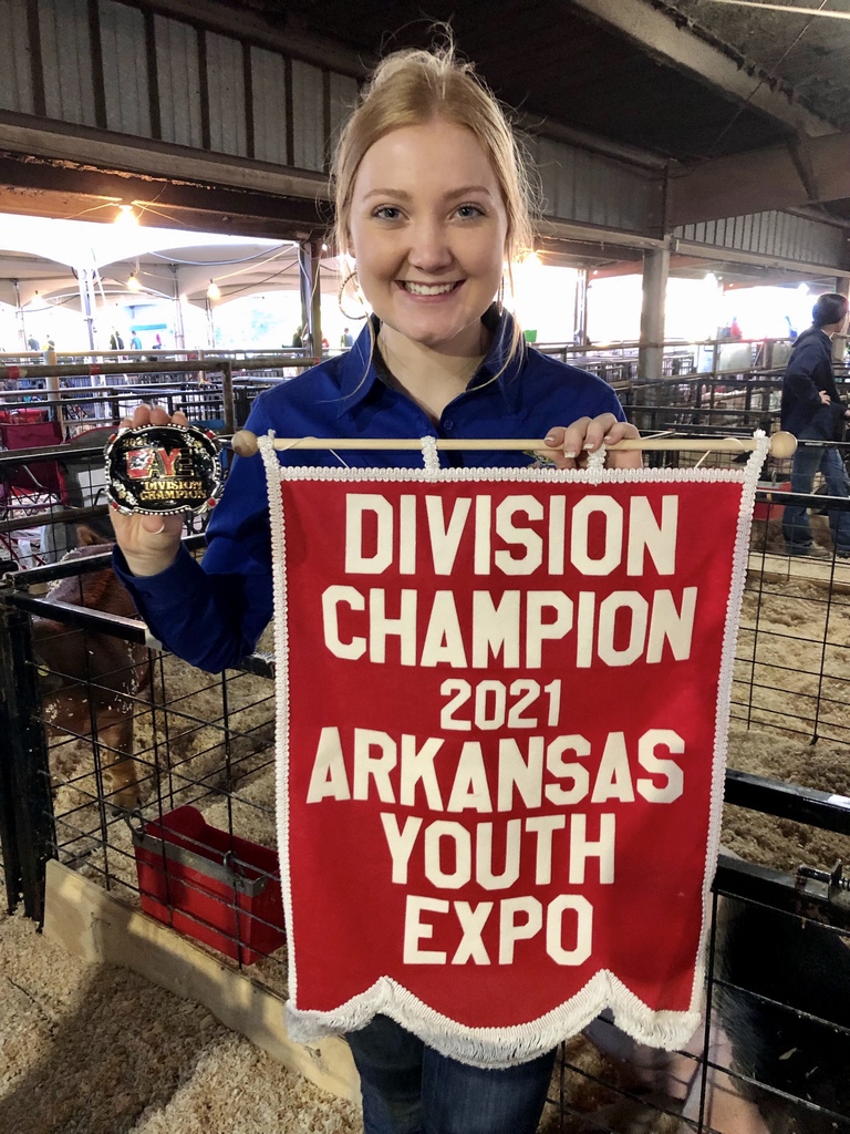 Dismang holding her champion flag & belt buckle