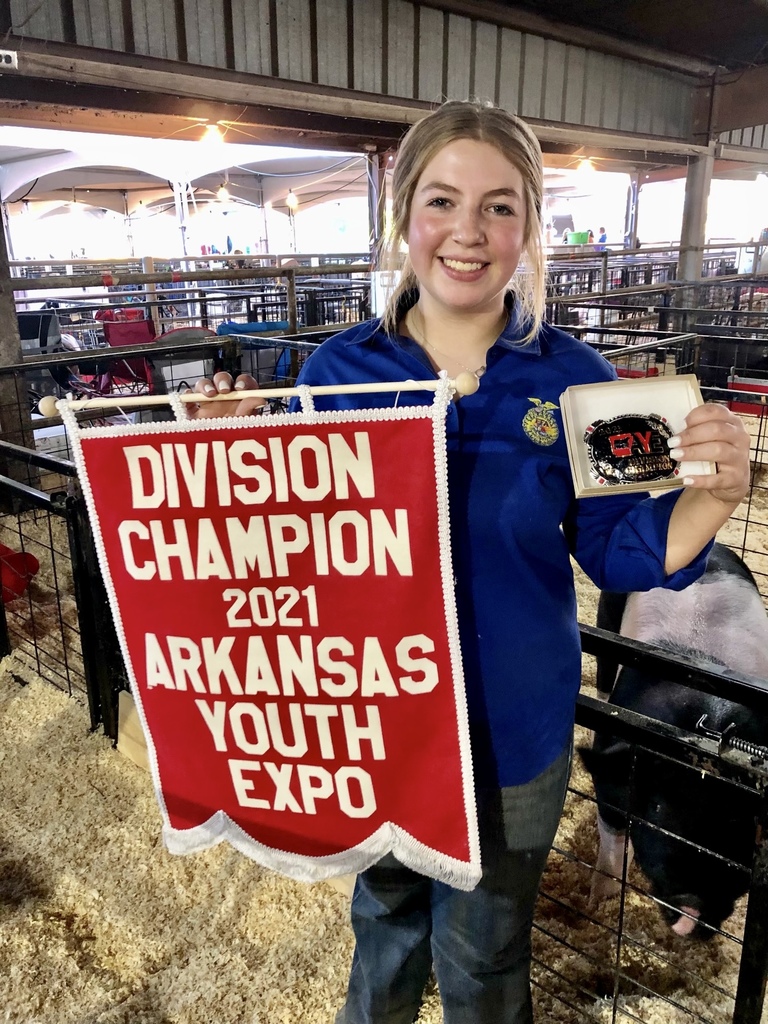 Mabry holding her champion flag & belt buckle