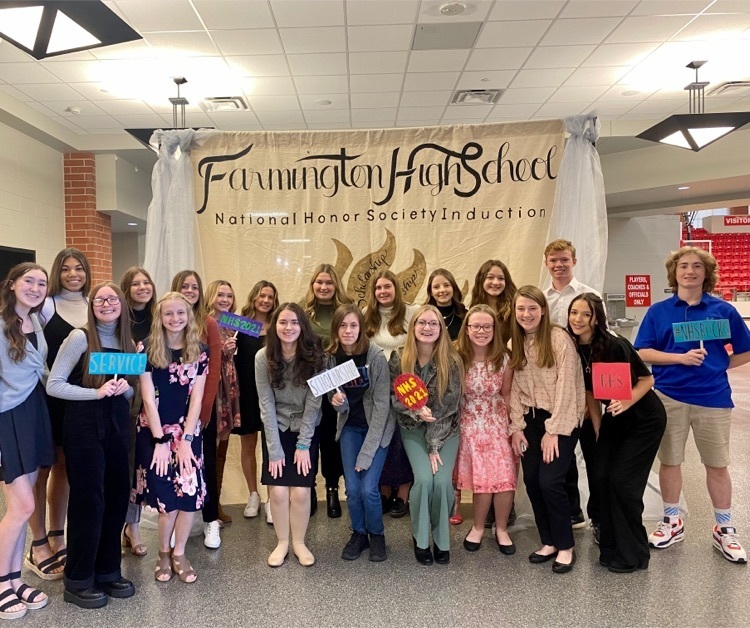 a group of students pose in front of a pack drop that says Farmington NHs