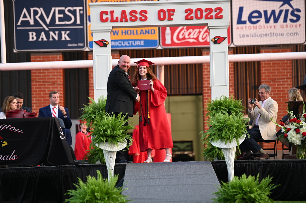 student receiving her diploma from principal Mr. Purifoy