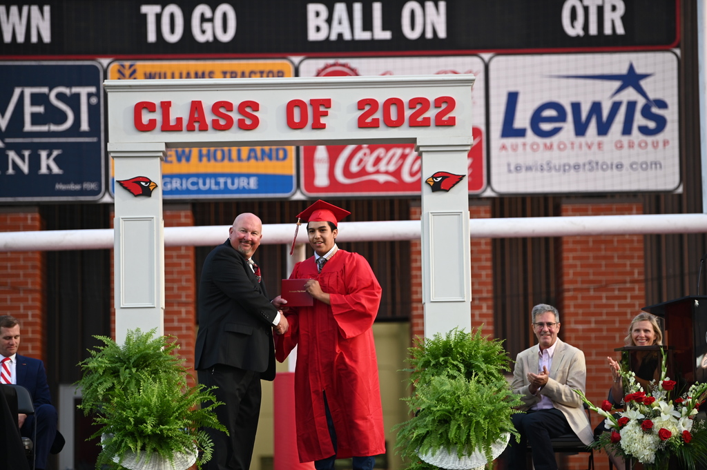 student receiving his diploma from principal Mr. Purifoy
