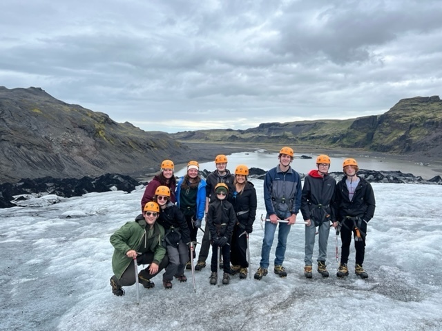 students lined up and posing on a glacier 