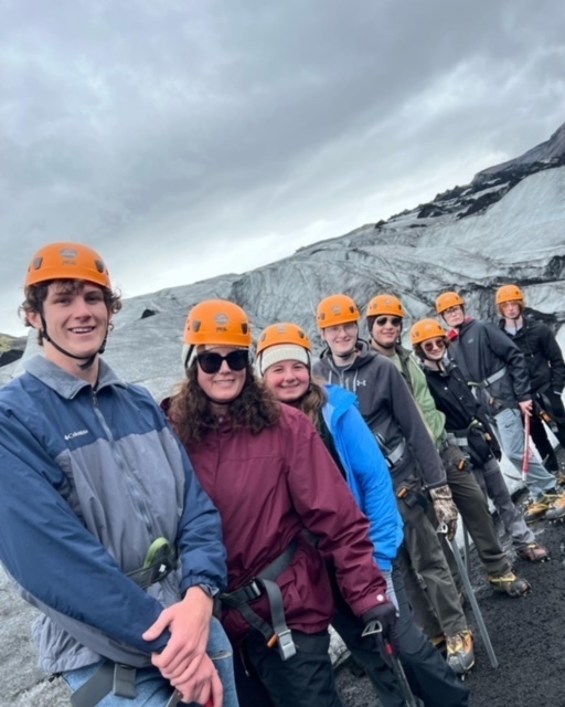 group of students lined up posing on a glacier 