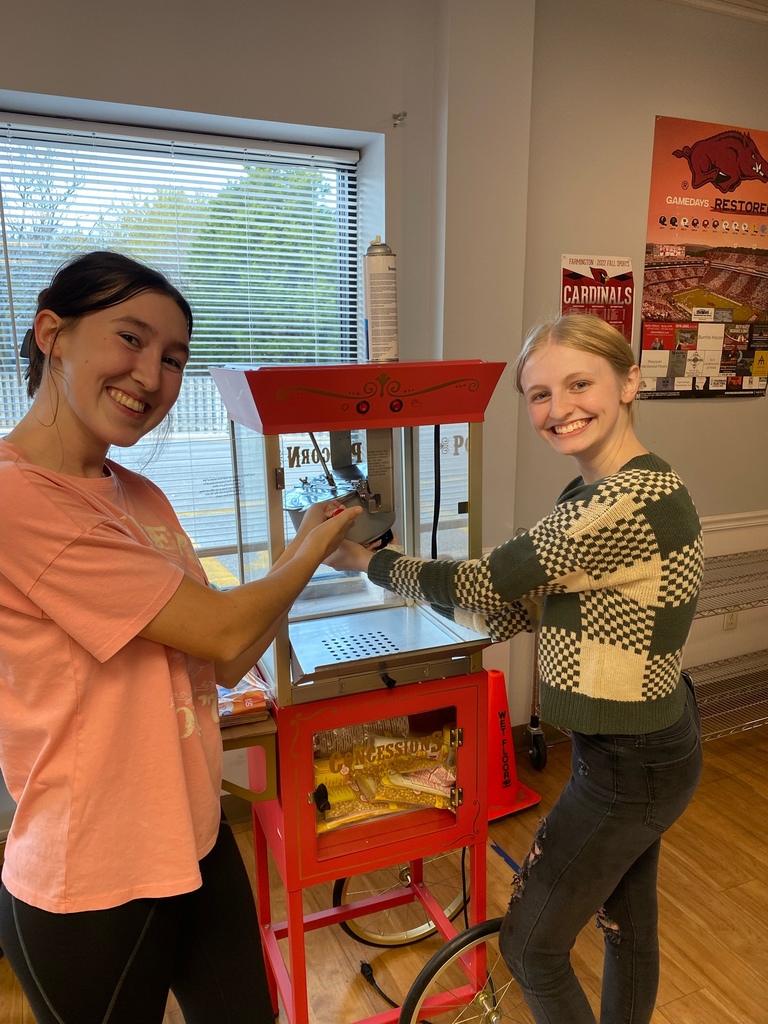 students cleaning a popcorn machine