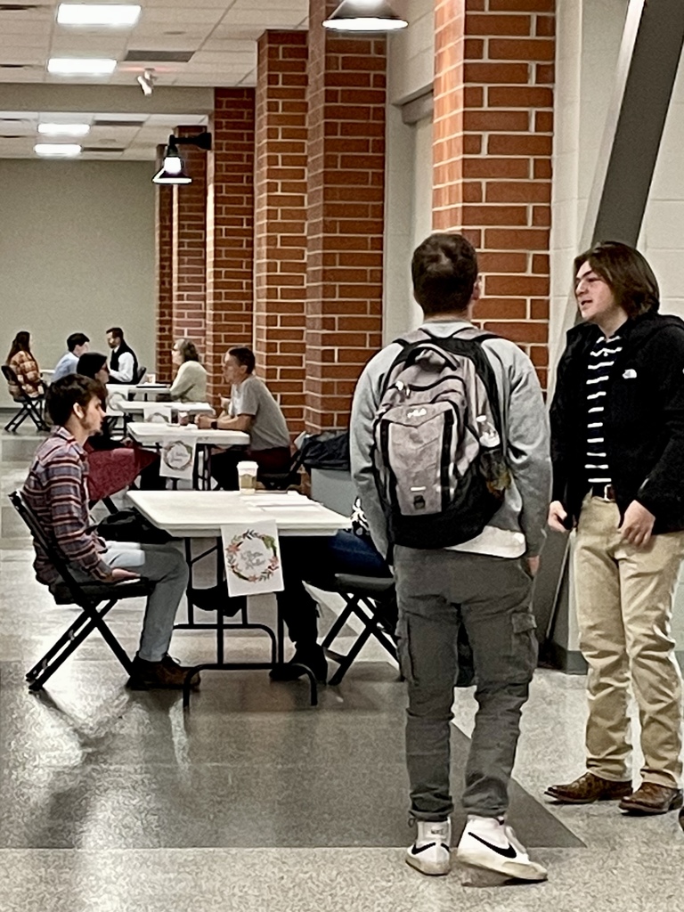 picture of several tables with interviewers and students