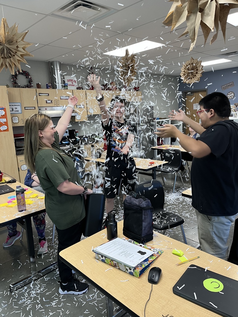 students throwing confetti in the classrom 