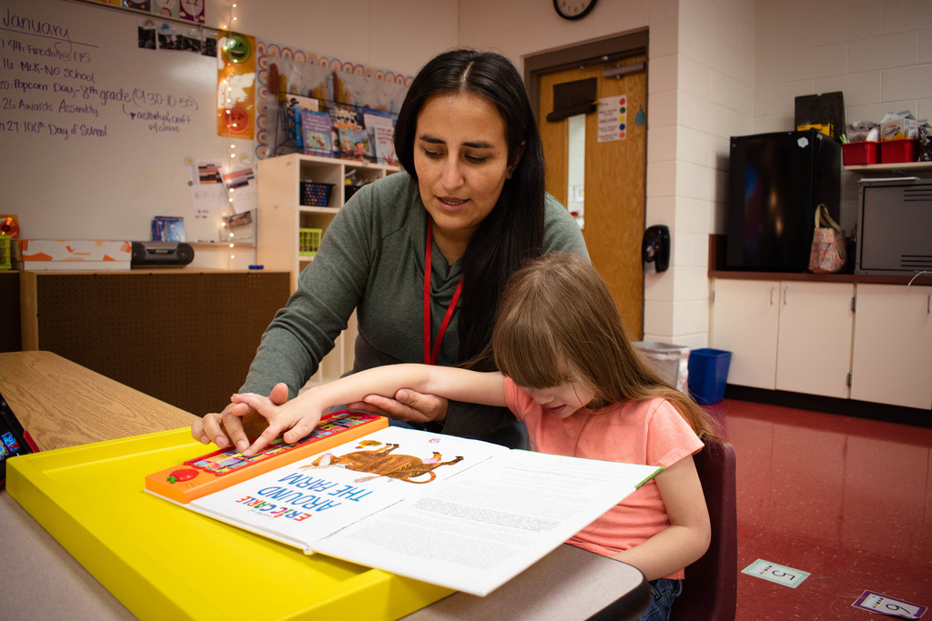 Miss Rosa reads with a student