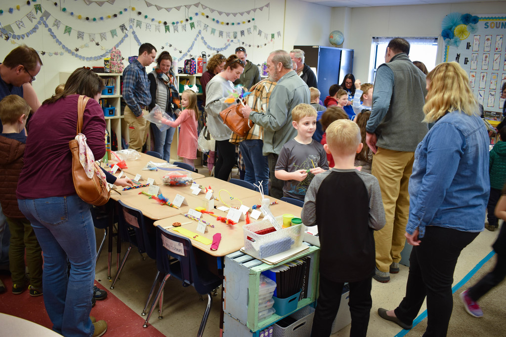 Students and families shop for inventions.