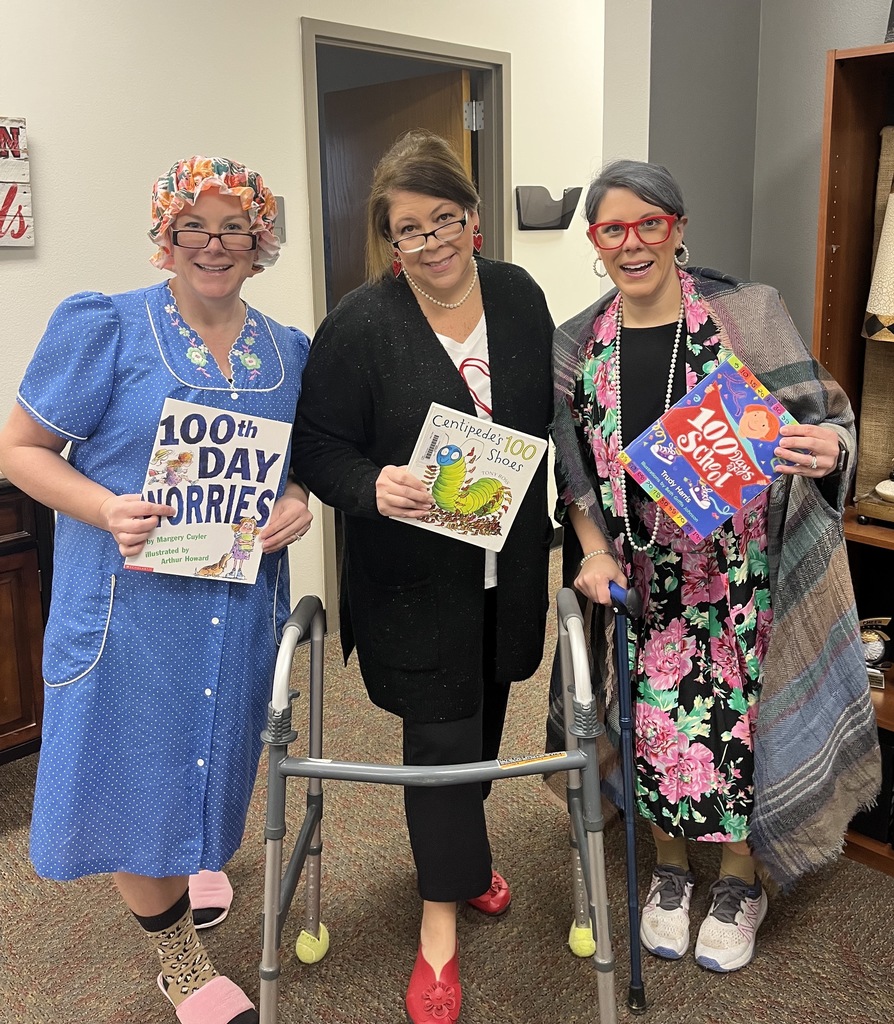 3 Grannies pose holding 100 days books