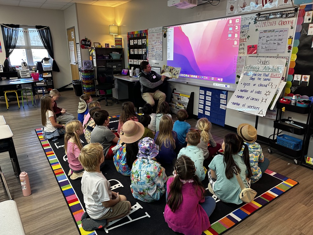 Mystery Reader reads to Mrs. Lewis' 1st grade class