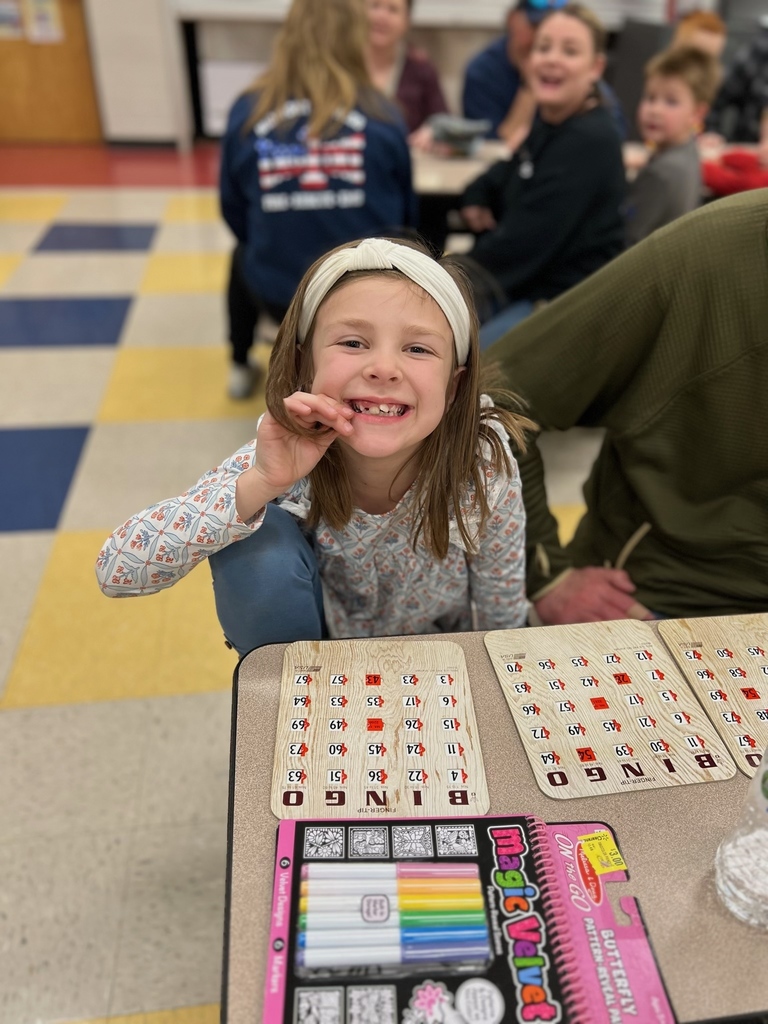 Student smiles with her Bingo card