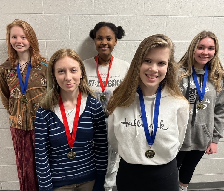 students posing with medals