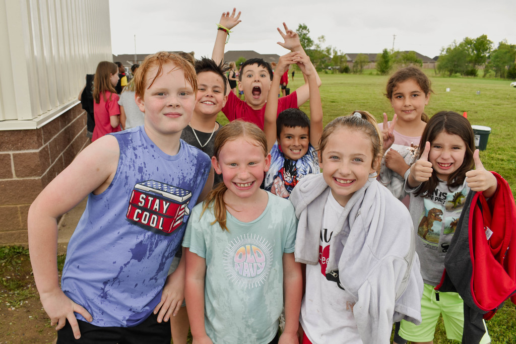 Students smile for the camera on field day