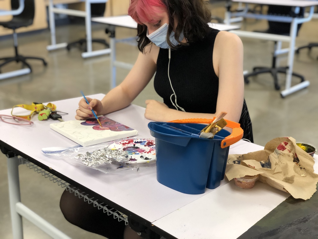 Student using paint and canvas