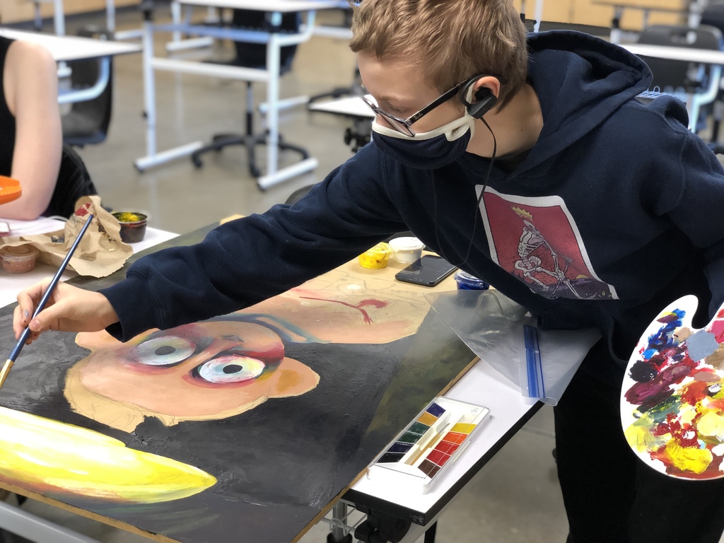 A student using paint as a medium